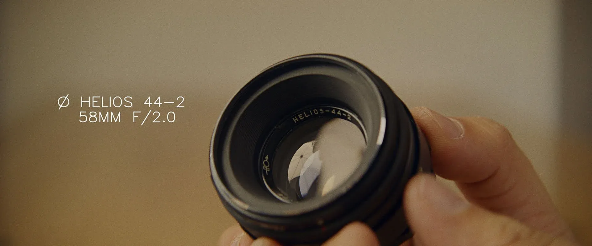 A hand holding the Helios 44-2 58mm f/2 lens